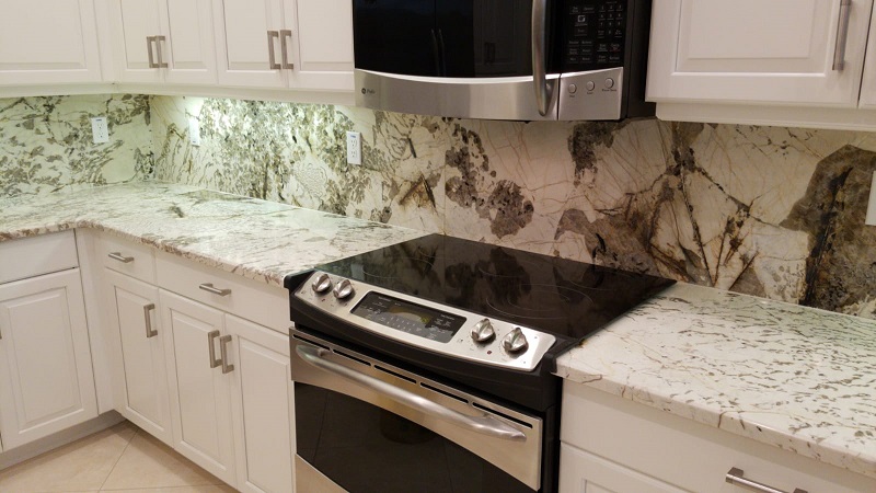 extra size kitchen counter top and full back splash done with a supper exotic quartzite and big crystal movements and a huge island